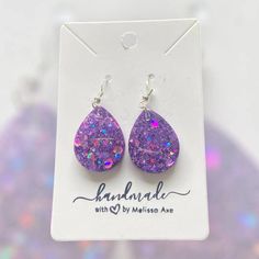 Each earring is handcrafted with care.  * Handcrafted with high-quality resin for durability and beauty. * Lightweight design for comfortable all-day wear. * Hypoallergenic for sensitive ears. * Each earring is unique and may be slightly different from what is pictured. No two earrings are completely alike. Material: * UV resin * Glitter * Hypoallergenic and nickel free Stainless Steel hardware Care: *To clean your earrings, use a damp cloth and wipe gently. *Remove the earrings before showering or swimming. *Avoid using chemicals, perfume, jewelry cleaners, or any aerosol products. Do not hesitate to send me a message if you have any questions. Please check my other listings at https://designsbymelissaa.etsy.com. Trendy Hypoallergenic Teardrop Earrings For Gift, Handmade Teardrop Earrings For Party, Trendy Hypoallergenic Teardrop Earrings, Trendy Teardrop Earrings As A Gift, Trendy Hypoallergenic Dangle Teardrop Earrings, Hypoallergenic Purple Dangle Teardrop Earrings, Trendy Hypoallergenic Teardrop Drop Earrings, Trendy Nickel-free Teardrop Earrings, Resin Teardrop Earrings For Gifts