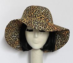 Wide Brim sun hat made with vintage cotton leopard fabric , lined in rayon print, the hat has a 2 section crown 3 1/2 " in length and a one piece 4" brim, a cotton band inside. One size fits most up to 23" Machine wash cold / hand dry Made in USA Press if needed / packable Fitted Hats With Curved Brim And Lining, Fitted Cotton Hat With Curved Brim, Fitted Lined Hats With Curved Brim, Fitted Lined Hat With Curved Brim, Fitted Wide Brim Sun Hat With Upf 50+, Reversible Wide Brim Bucket Hat One Size, Reversible Adjustable Brimmed Sun Hat, Adjustable Reversible Sun Hat With Short Brim, Adjustable Wide Brim Reversible Sun Hat