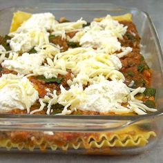 a casserole dish with meat, cheese and spinach