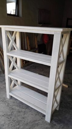 a white shelf sitting on top of a cement floor