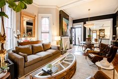 a living room filled with furniture and lots of windows