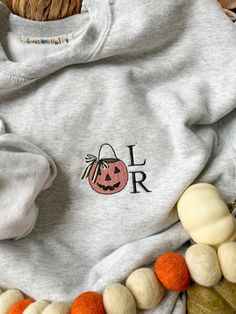 cozy up for fall in the sweetest embroidered sweatshirt featuring a classic pumpkin bucket with striped bow and your 2 initials of choice ::THE DETAILS:: - machine embroidered along left side chest - 2 character limit for monogram in font as shown - gildan sweatshirt & t-shirt, please review size chart in photos before ordering - machine washable x tumble dry low ::PLEASE NOTE:: - due to the customized nature of this item, refunds or returns cannot be accepted - please ask any questions before ordering CUSTOM ORDERS WELCOME! if you don't see what you're looking for - message me and we can work together to make your perfect sweatshirt! Fall Gift Sweatshirt With Embroidered Logo, Customizable Sweatshirt For Fall And Gifts, Custom Embroidery Sweatshirt As Fall Gift, Customizable Sweatshirt For Fall Gift, Fall Custom Embroidery Sweatshirt Gift, Personalized Cotton Sweatshirt For Fall, Customizable Fall Sweatshirt For Gifts, Custom Embroidered Fall Sweatshirt, Personalized Fall Sweatshirt For Gift