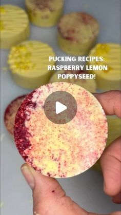 a person holding up a piece of raspberry lemon poppy seed cupcakes