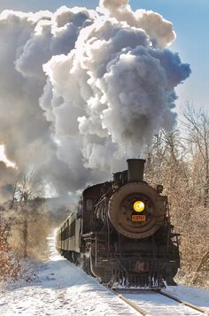 a train is traveling down the tracks in the snow