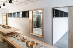 there are many donuts on the counter in this room and one has a mirror above it