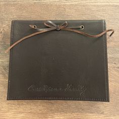 a brown leather case with a ribbon on the front and writing on the back that says once upon a family