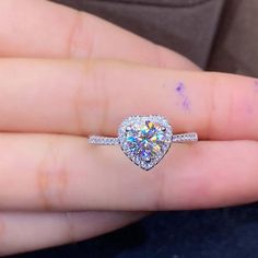 ❤ Moissanite Ring Information❀ Moissanite Size and Weight: 6.5 mm, 1 ct. ❀ Moissanite Clarity: VVS1.❀ Moissanite Shape: Brilliant Round Cut.❀ Moissanite Color: D Colorless.❀ Moissanite Make: Great Quality.❀ Moissanite Ring Setting: Prongs Setting.❀ Accent stone: dainty cubic zirconia ( cz diamond).❀ Metal Materials: 925 sterling silver, 18K gold plated.❀ Metal color: Silver, yellow gold color ❤ Customize Making RingRing size from US #3 to US #16.Accept customize in solid 9K / 14K / 18K yellow go Heart Halo Ring, Heart Engagement, Finger Jewelry, Handmade Sterling Silver Rings, Band Engagement Ring, Cz Diamond, Moissanite Ring, Rings Simple, Silver Material