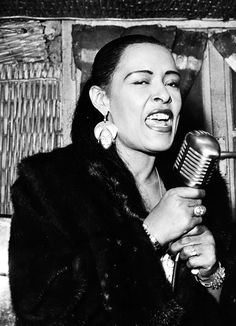 a woman holding a microphone in her right hand