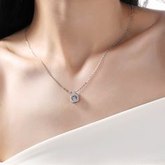 An eye-catching round moissanite dances with ease at the center of this appealing women's necklace, expressing your unstoppable love. Additional round gem set in sterling silver frame the center. Features Moissanite was originally found in meteorites(Chemical name: Silicon Carbide). It was first discovered in 1893, while a scientist was examining meteor samples from a crater in Arizona. After many years, Read Your Heart experts has been recreated moissanite in the laboratory, that make the gemst Dazzling Lab Grown Diamond Necklaces, Diamond White Solitaire Necklace With Cubic Zirconia, White Solitaire Necklace With Round Pendant, Silver Necklace With Round Halo Pendant, Silver Necklace With Halo Setting And Round Pendant, Silver Necklace With Halo Design And Round Pendant, Dazzling Silver Solitaire Pendant Necklace, Silver Diamond Solitaire Necklace, Dazzling Style, Silver Solitaire Necklace With Halo Design