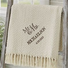 a personalized blanket with the name mr and mrs on it hanging from a ladder