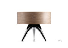 a wooden table with metal legs and a round top on it's stand, in front of a white background