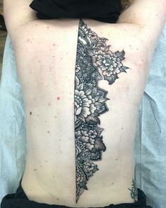 a woman's lower back tattoo with flowers on it