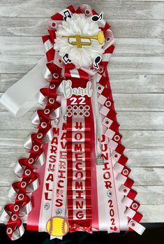 a red and white christmas tree made out of candy wrappers with musical instruments on it