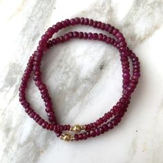 Single-strand bracelet of rich, berry-red genuine faceted ruby rondelle beads. Accented with 14k goldfill bead at center, with a gold-lined crystal bead on each side.  SPECIAL OFFER: Order any three (3) bracelets, and receive 25 PERCENT OFF all 3. Message me before you purchase and I will create listing with discount. Length: please indicate wrist size. If you are giving as a gift and aren't sure of size, say 7 inches, which will fit most; I'm happy to exchange if need be for a different size if Faceted Rondelle Ruby Jewelry, Faceted Ruby Rondelle Jewelry, Beaded Pillow, Single Bracelet, Teal Ribbon, Ruby Bracelet, Beaded Boxes, Stackable Bracelets, Amethyst Bracelet