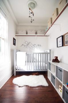 a baby's room with white walls and wooden floors