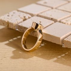 a gold ring sitting on top of a wooden table