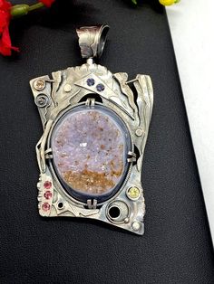 Artisan Gemstone Druzy Pendant Hand-made Sterling Silver. Stones used: Brazilian Druzy, Pink Tourmaline, Yellow Sapphire, Citrine,  Mystic Topaz. Height - 76mm, Width – 46mm.Unique Handcrafted One-of a-kind Design PendantEach Piece of Jewelry in my Collection is Absolutely One of a Kind!When you start wearing a piece of my jewelry you will fall in love with it more and more each day and feel that good Energy and Love that I pass into it while creating this piece of Art.A piece of Art created for Artisan Jewelry With Large Stone Round Pendant, Unique Rectangular Pendant With Natural Stones, Artisan Oval Silver Gemstones, Unique Oval Pendant Jewelry With Large Stone, Amulet Style Pendant Jewelry With Stones, Artisan Sterling Silver Pendant Necklace, Spiritual Pendant Jewelry With Stone Setting, Luxury Large Stone Pendant Jewelry, Silver Oval Pendant Gemstones For Jewelry Making