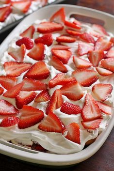 there is a cake with strawberries on it and white frosting in the middle