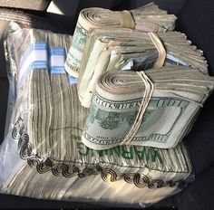 stacks of money sitting on top of each other in the back seat of a car