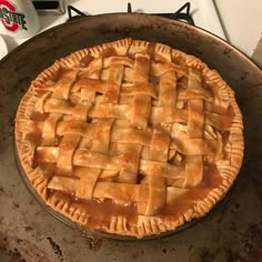 an apple pie sitting on top of a stove