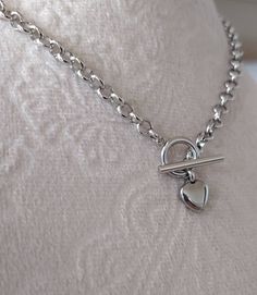 Handmade Lightweight All Silver Color Stainless Steel Heart Necklace, Stainless Steel Toggle Closure Stainless Steel Silver Color Rolo chain, ~5mm wide Stainless Steel Heart Charm, ~10mm **Total length is for the chain and toggle only not including the heart pendant** Same Necklace available in Gold Color stainless Steel, please see the below listing: https://www.etsy.com/listing/1108247644/gold-heart-necklace-or-bracelet-dainty?click_key=83fb19d44276289d12c77af145231997ccad49ff%3A1108247644&cli Silver Heart Necklace With Adjustable Chain, Silver Heart Toggle Necklace For Gift, Heart-shaped Metal Necklace With Silver Chain, Adjustable Heart-shaped Silver Necklace, Heart-shaped Metal Toggle Necklace With Adjustable Chain, Diy Jewelry Unique, Toggle Necklace, Necklace Chain Lengths, Gold Heart Necklace