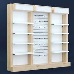 an empty wooden bookcase with white shelves on the front and back sides, against a blue background