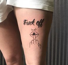 a woman's leg with a tattoo on it that reads, tuck off and finger