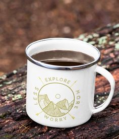 a cup of coffee sitting on top of a wooden table next to a tree trunk