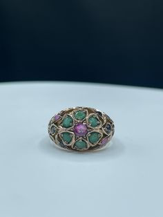 Discover the beauty of natural gemstones with this exquisite Handmade Natural Sapphire & Emerald 10k Yellow Gold Ring. This stunning piece is meticulously crafted to showcase a vibrant mix of pink and blue sapphires, complemented by lush emeralds. Perfect for any jewelry lover, this ring is a one-of-a-kind treasure. Features: *Ring Size: 7.75 *Materials: 10k yellow gold *Gemstones: Natural pink and blue sapphires, emeralds *Design: Intricate and unique, highlighting the beauty of each gemstone *Style: Handmade and one-of-a-kind This ring's intricate design and rich color palette make it a standout piece for any occasion. Whether you're treating yourself or looking for a special gift, this handmade ring is sure to impress. Luxury Multicolor Ruby Ring, Multicolor 14k Gold Gemstones, Heirloom Multicolor Jewelry With Accent Stones, Heirloom Multicolor Gemstone Ring, Fine Jewelry With Multi-stone Pink Sapphire, Multicolor Ruby Ring In Fine Jewelry Style, Multicolor Ruby Ring Fine Jewelry, Multicolor Oval Ruby Ring For Gift, Multicolor Oval Ruby Ring Gift