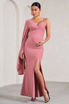 Perfect for baby showers. weddings and everything in between. Rhea is a formal wardrobe must-have. Crafted in a soft pink shade of our signature stretch jersey. this v-neck maternity maxi dress was designed with your comfort at the forefront. Characterised by a singular cape sleeve. Rhea concludes with subtle bump ruching and a high-leg split. Features - Premium stretch jersey- V neckline- Single cape sleeve- Adjustable cami strap- Invisible zip closure - Bump ruching - High-leg split- Maxi leng Pink Fitted Maternity Dress For Party, Pink Stretch Maternity Dress, Pink Fitted Maternity Dress For Wedding, Fitted Pink Maternity Dress In Feminine Style, Feminine Fitted Pink Maternity Dress, Fitted Pink Feminine Maternity Dress, Pink Fitted Maternity Dress, Elegant Pink Maternity Dress For Party, Feminine Pink Maternity Dress For Party