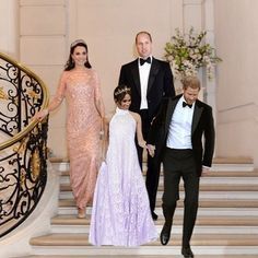 four people in formal wear walking down the stairs