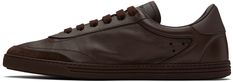 Low-top grained calfskin sneakers in brown. · Suede trim at toe · Lace-up closure · Logo embossed at tongue · Padded collar · Perforated detailing at sides · Logo-embossed textured rubber midsole · Treaded rubber sole Supplier color: Moro/Ebano Brown Calf Leather Sneakers With Contrast Sole, Brown High-top Calf Leather Sneakers, Brown Calf Leather Sneakers With Rubber Sole, Brown Calf Leather Sneakers With Stitched Sole, Designer Brown Calf Leather Sneakers, Designer Brown Sneakers With Stitched Sole, Brown Calf Leather Sneakers With Leather Sole, Brown Calf Leather Plain Toe Sneakers, Dolce Gabbana Sneakers