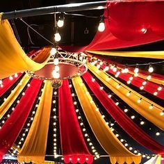 the inside of a circus tent decorated with lights