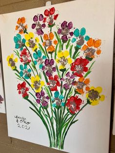 an art project with flowers painted on paper