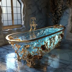 an ornate bathtub with blue glass and gold decorations on the sides, in front of a window