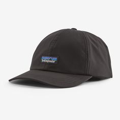 the patagonia hat is black and has a blue patch on the front of it