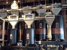 several large black tanks sitting inside of a room next to a light fixture and some lights