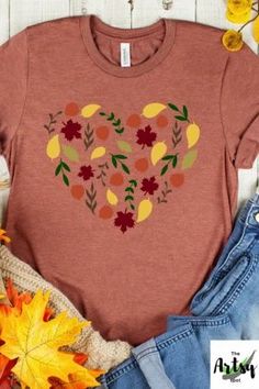 I love fall shirt, fall leaves shirt, leaves in a heart shirt, I Heart fall shirt, cute fall shirt, fall t-shirt, This trendy fall design with a heart made of leaves is a perfect way to show your love of everything fall. The fall leaves design in the shape of a heart says it all! The cute fall shirt would be a great piece of fall apparel to add to your wardrobe. Pair this fall t-shirt with jeans, boots and a jacket or cardigan and you'll be stylin' for the fall season. Cute Red Fall Tops, Cute Fall Tops With Heart Graphic, Cute Heart Graphic Tops For Fall, Fall Long Sleeve Top With Heart Graphic, Cute Heart Print Tops For Fall, Fall Crew Neck Top With Heart Graphic, Fall Cotton T-shirt With Heart Print, Fall Heart Print Cotton T-shirt, Casual Fall Tops With Heart Graphic