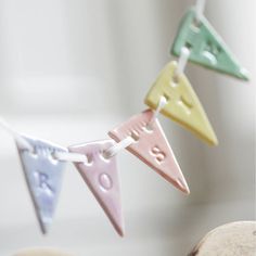 some little colorful pennants hanging from a string