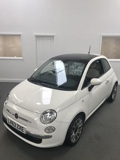 a small white car parked in a garage