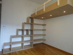 an empty room with some shelves and stairs