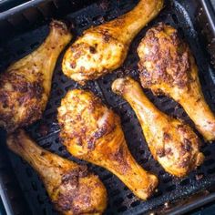 chicken legs are cooking on the grill