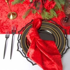 a place setting with red napkins and silverware