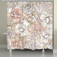 a shower curtain with flowers and leaves on the outside, in front of a bathtub