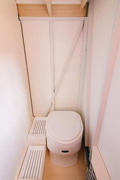 a white toilet sitting in the corner of a room