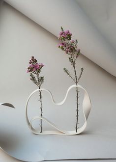 two white vases with pink flowers in them