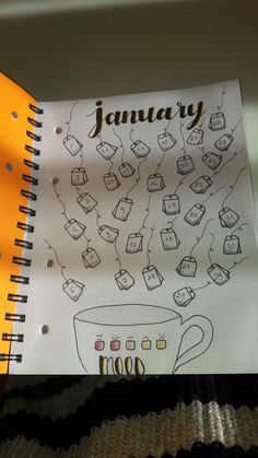 a notebook with an image of a coffee cup and the words january written on it