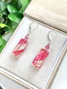 Pretty in pink! Rectangle Murano glass beads are shimmering with pink and genuine sterling silver foil. A Swarovski crystal in pink accents the glass bead in a great shine as well! The beads hang on Sterling silver lever back ear wires for perfect comfort and security. The earrings hang 2 inches. A wonderful gift for any occasion and arrives in a standard gift box. ✨ Authentic Murano Glass: Each pair of earrings showcases the unparalleled beauty of Murano glass, renowned for its vibrant colors a Elegant Nickel-free Pink Earrings, Handmade Pink Crystal Sterling Silver Earrings, Handmade Pink Crystal Earrings In Sterling Silver, Pink Dangle Crystal Earrings For Gift, Elegant Pink Rectangular Earrings, Handmade Pink Glass Jewelry, Nickel-free Pink Jewelry For Party, Pink Crystal Ear Wire Earrings For Gift, Pink Sterling Silver Crystal Earrings As Gift