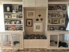 there is a dog bed in the middle of this room with built - in bookshelves