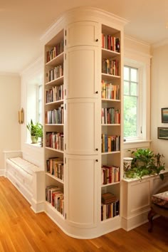 a room with bookshelves and wooden floors